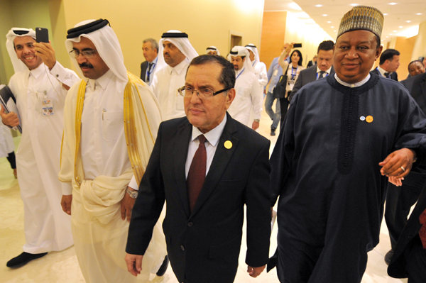 In this photo dated on Wednesday, Algerian Energy Minister Noureddine Boutarfa, (centre) leaves the international conference centre in Algiers, Algeria, with  minister of energy and industry of Qatar, Bin Saleh Al Sada (left) and acting Secretary General of OPEC Mohammed Barkindo (AP photo)
